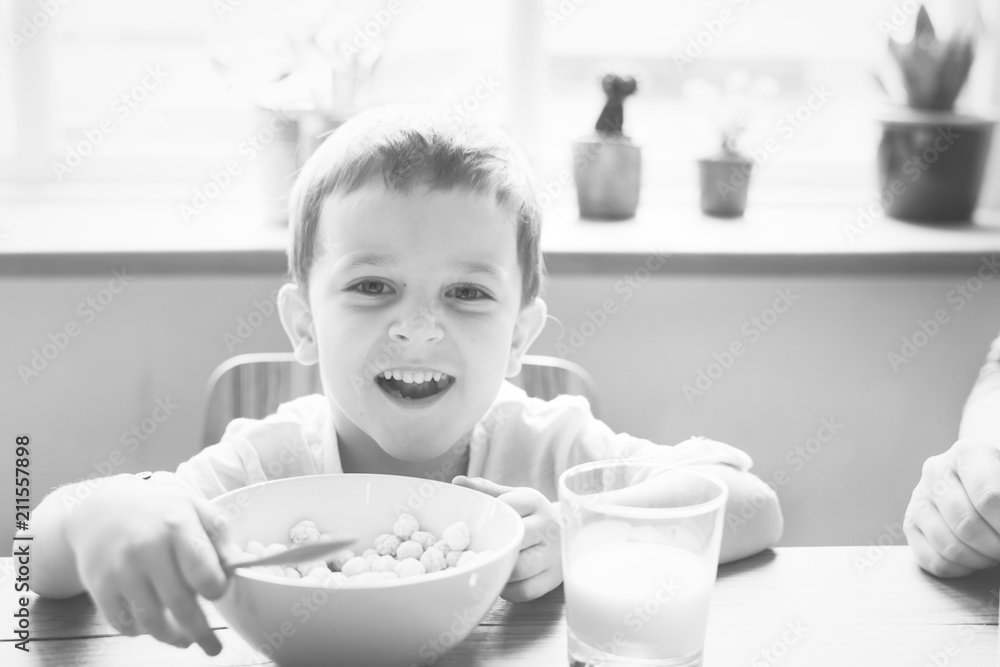 Little boy smiling while eating his breakfast Little boy smiling while eating his breakfast