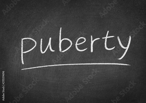 puberty concept word on a blackboard background