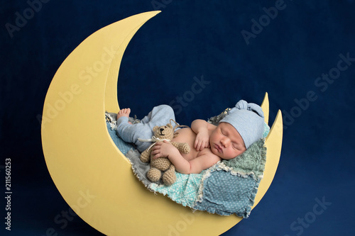 Newborn Boy Sleeping on the Moon with Teddy Bear