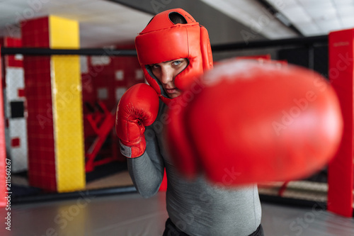 Boxing glove close-up, male boxer engaged in training in the gym, in a cage for a fight without rules © Shopping King Louie