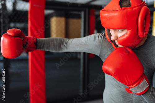 Male boxer engaged in training in the gym, in a cage for a fight without rules, Boxing coach © Shopping King Louie