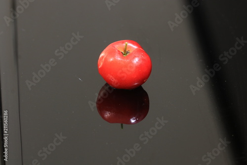Close up red cherry and reflection on the ground