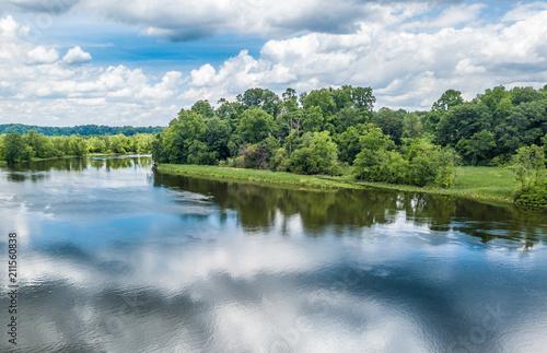 Reflection of the cloudy sky in the water of little lake