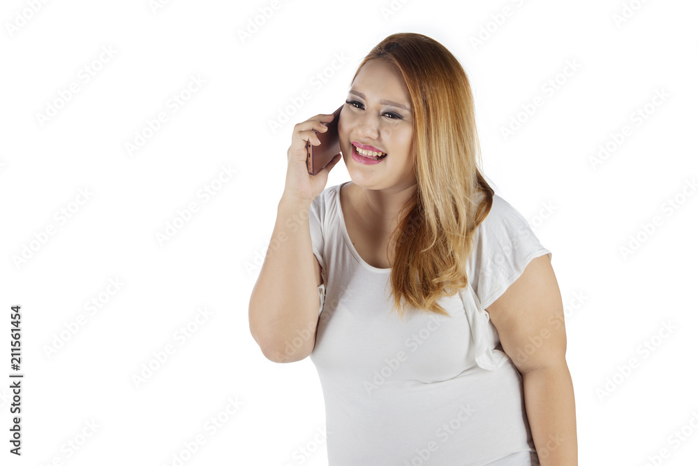 Caucasian fat woman speaking on a phone Caucasian fat woman speaking on a phone