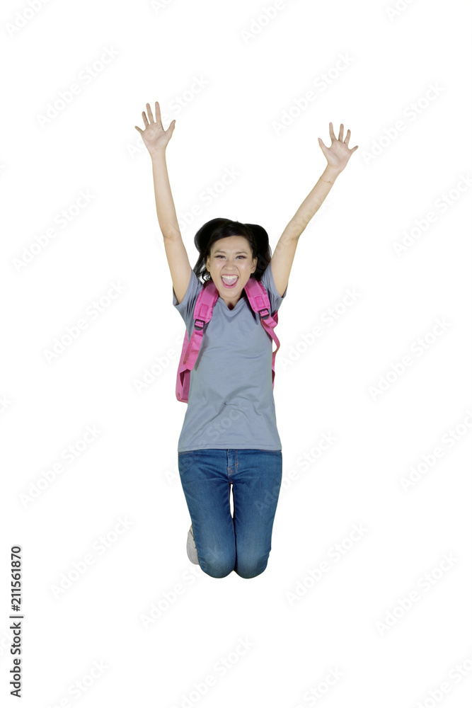 Female college student jumping in the studio