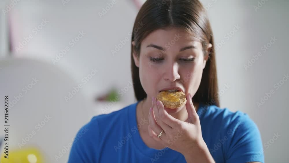 Young Woman Eating Breakfast At Home On Sunday Young Woman Eating Breakfast At Home On Sunday