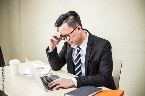 Business man stressed and have a headaches after found job have a problem and trouble