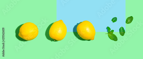 Fototapeta Naklejka Na Ścianę i Meble -  Fresh lemon pattern on a bright color background flat lay
