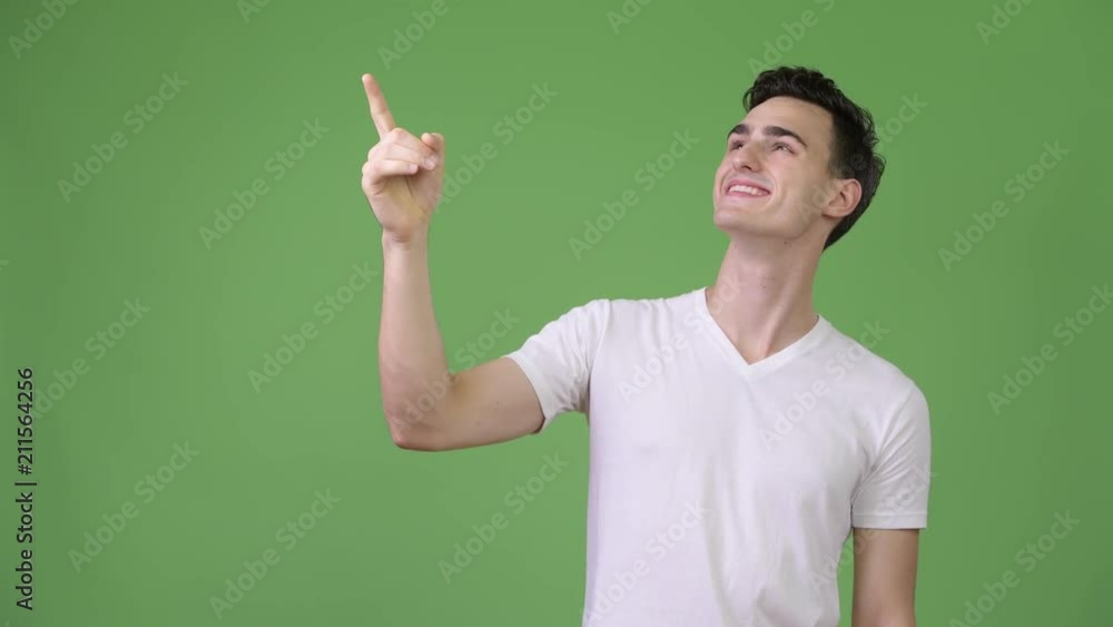 Young handsome man thinking while pointing finger up Young handsome man thinking while pointing finger up