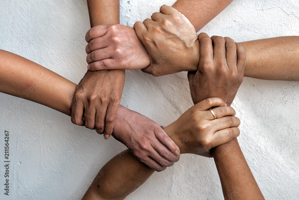Group of young business people united, joining , combine hands together  expressing positive, unity, volunteer , teamwork concepts. фотография Stock  | Adobe Stock
