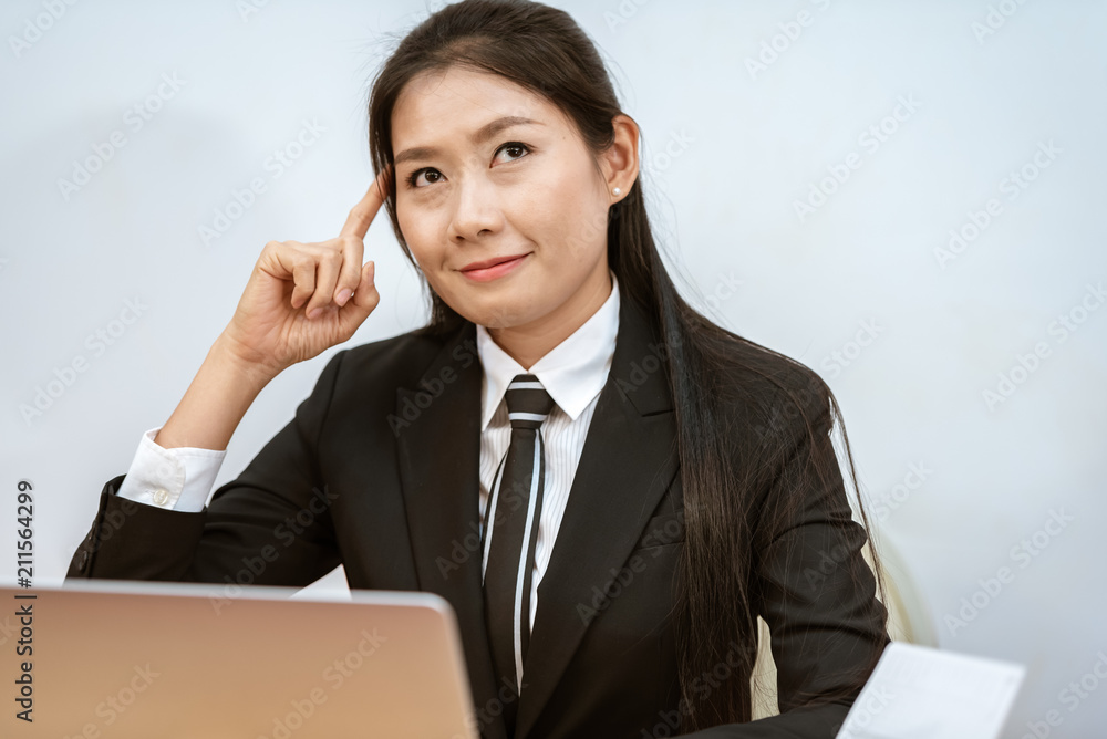 Portrait of young thoughtful and cheerful smiling thinking and planing business woman.