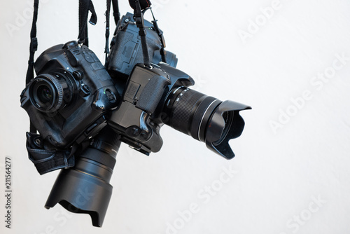 Pile of modern DSLR cameras on white isolate background, how to choose dslr camera concept. photo