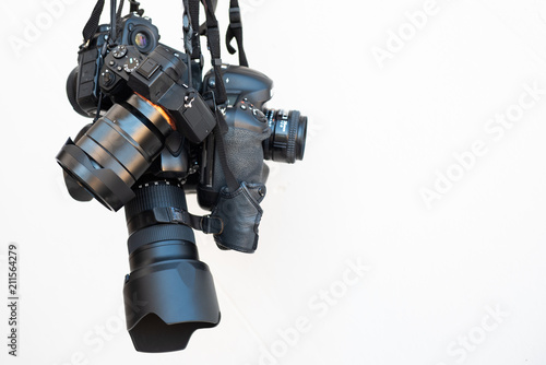 Obraz na plátne Pile of modern DSLR cameras on white isolate background, how to choose dslr camera concept such as full frame , mirrorless ,micro four thirds 4/3 sensor