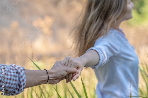 Asian couple holding hands travel together in the forest. 
