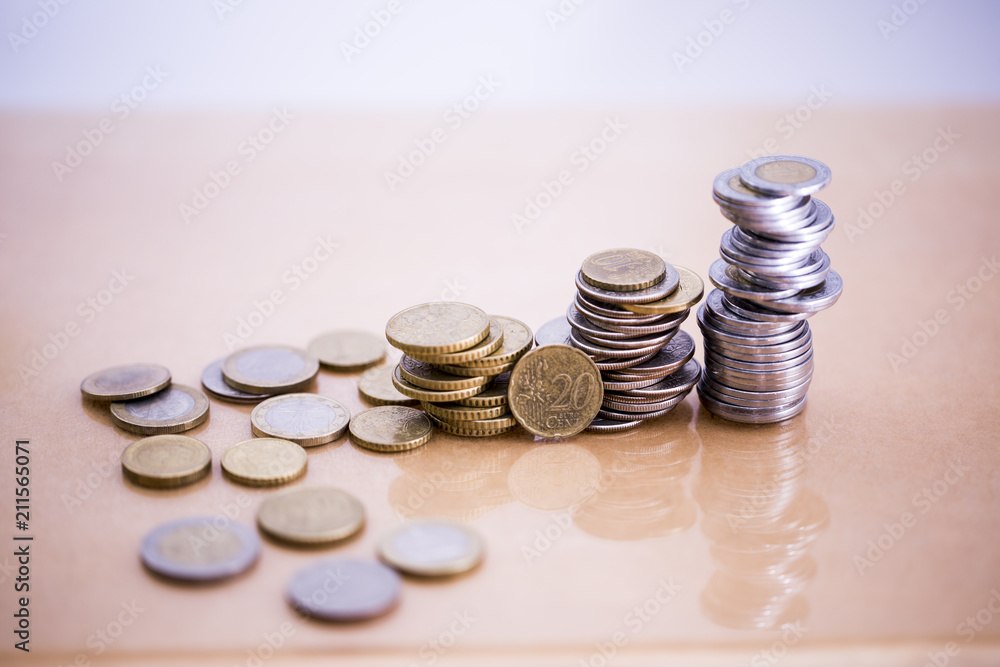 Mortgage loan and real estate tax macro financial Concept, Scandinavian house model and pile of coins money on brown wooden frame, with copy space in middle of the frame. Mortgage loan and real estate tax macro financial Concept, Scandinavian house model and pile of coins money on brown wooden frame, with copy space in middle of the frame.