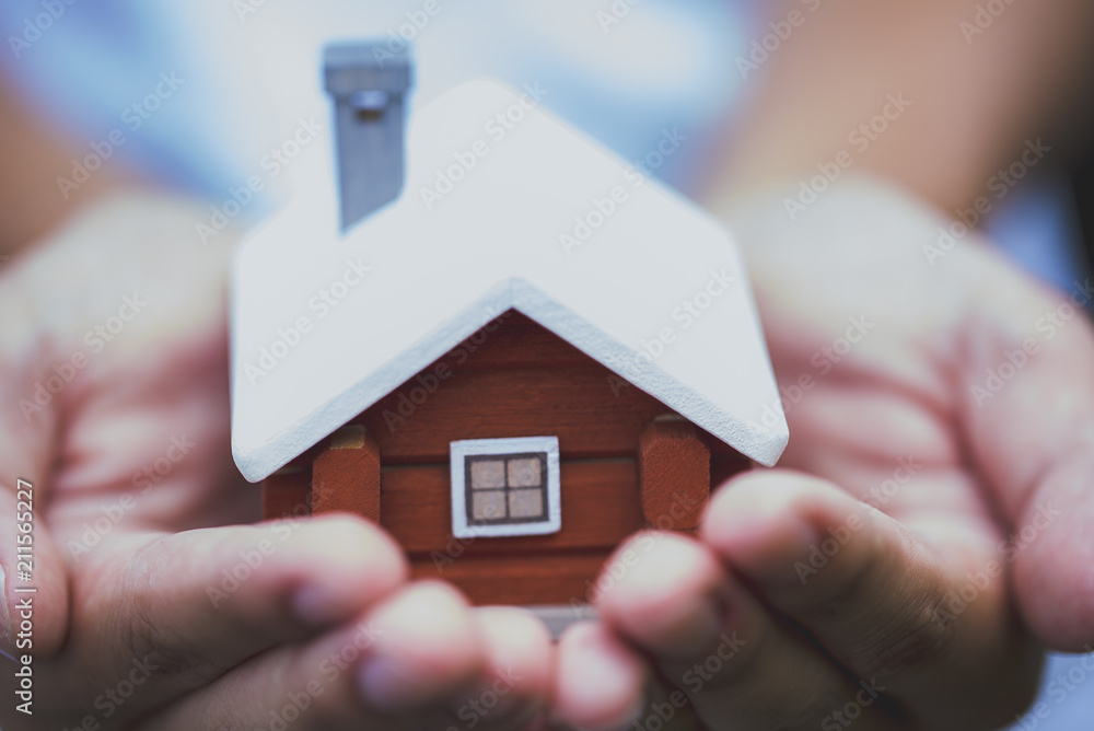 Insurance house concept, scandinavian house model with man 's hand, protecting your new property. Insurance house concept, scandinavian house model with man 's hand, protecting your new property.