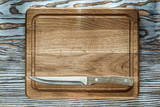 Carving board knife on wooden surface