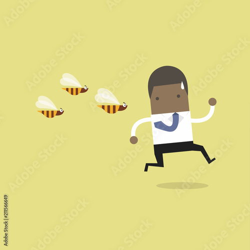 African businessman running away from dangerous insects.