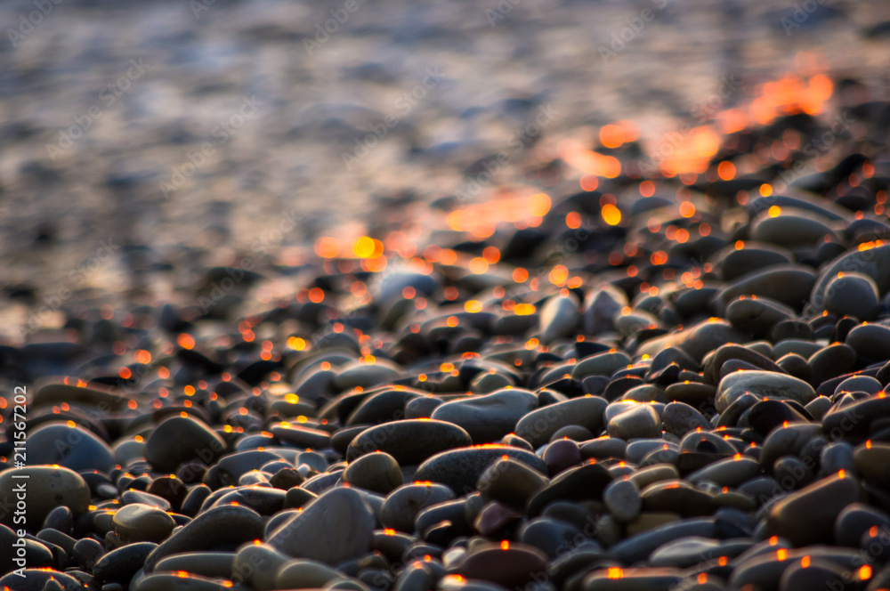 Obraz premium pebble stones on the sea beach, the rolling waves of the sea with foam