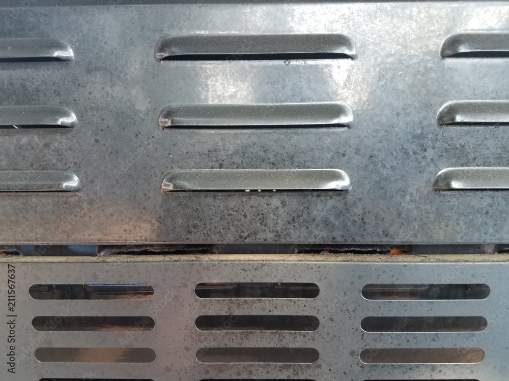 air vents on back of dirty barbecue grill