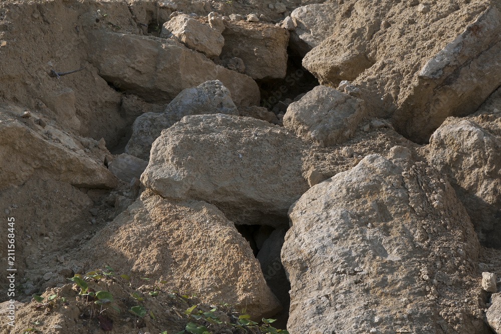 Sandstone rocks in a sandy quarry. Natural background. Sandstone rocks in a sandy quarry. Natural background.