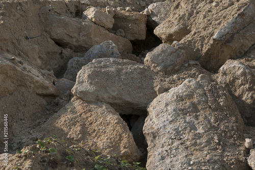 Sandstone rocks in a sandy quarry. Natural background.