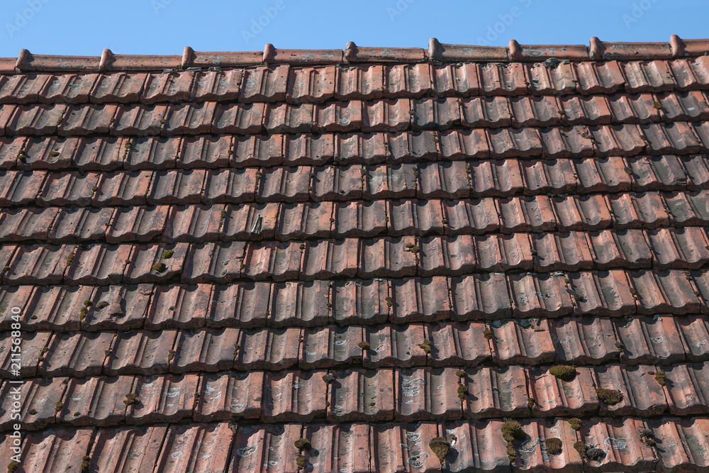 Fototapeta premium Closeup texture of old red roof tiles.Old roof at village house.