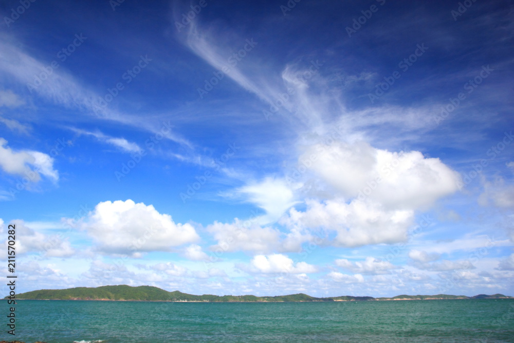 Tropical and calm sea with islands on the horizon and white clouds,Blue sky for background.