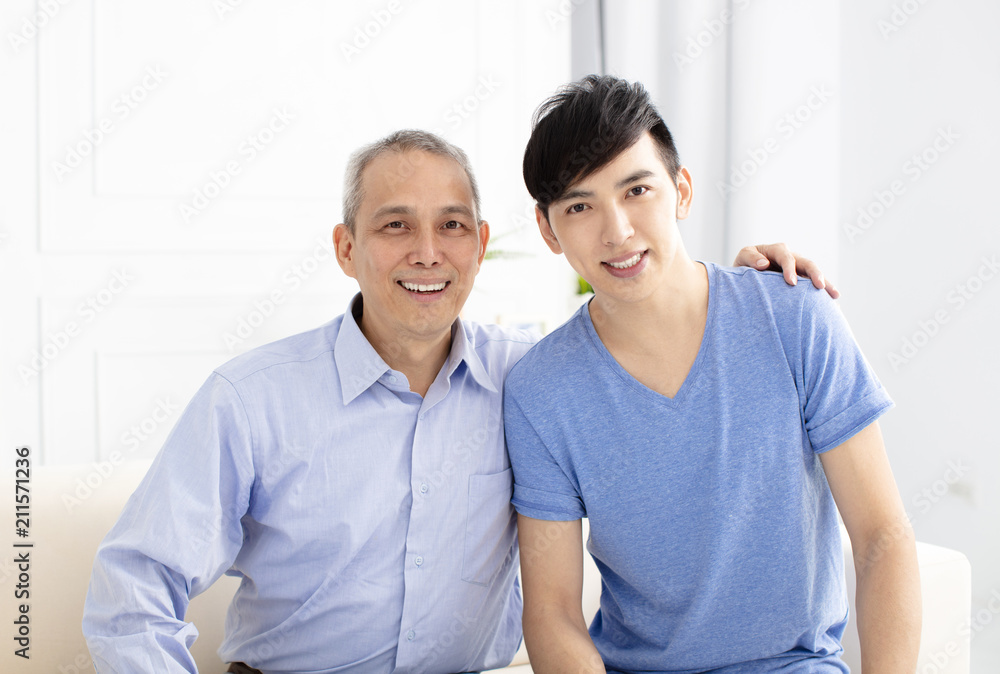 smiling senior father and adult son at home smiling senior father and adult son at home