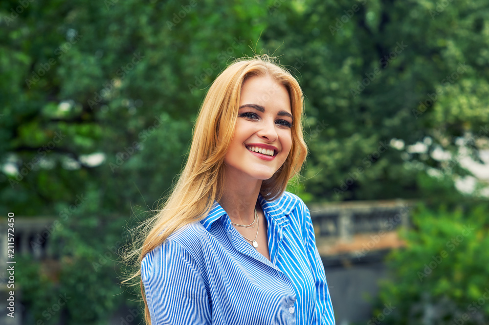 Attractive young girl in town. Beautiful fashionable woman in summer outdoors . The concept of women's fashion Attractive young girl in town. Beautiful fashionable woman in summer outdoors . The concept of women's fashion