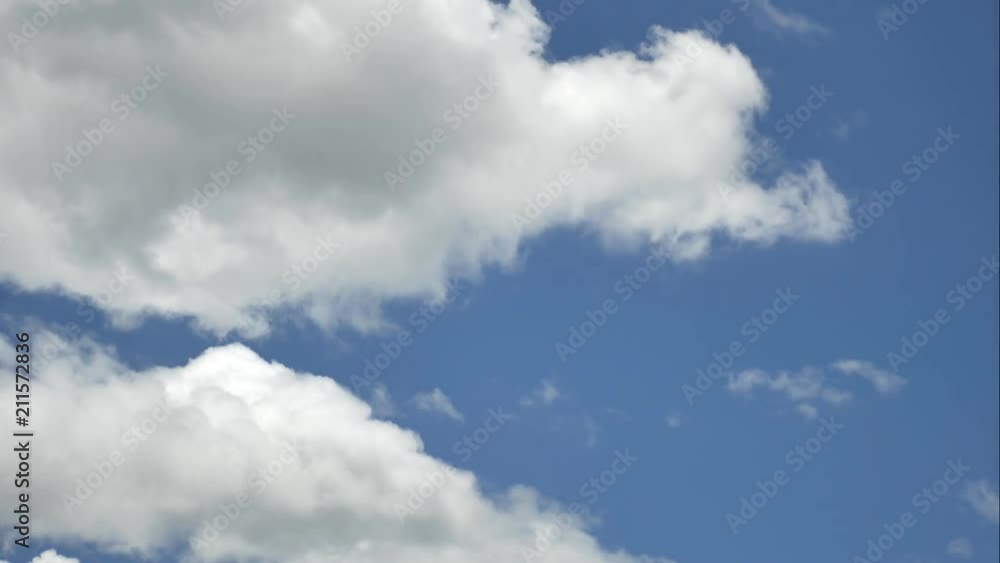 Time lapse of the serene blue sky is adorned with puffy, fluffy white clouds, creating a mesmerizing cumulus cloud cloudscape. Time lapse of the serene blue sky is adorned with puffy, fluffy white clouds, creating a mesmerizing cumulus cloud cloudscape.
