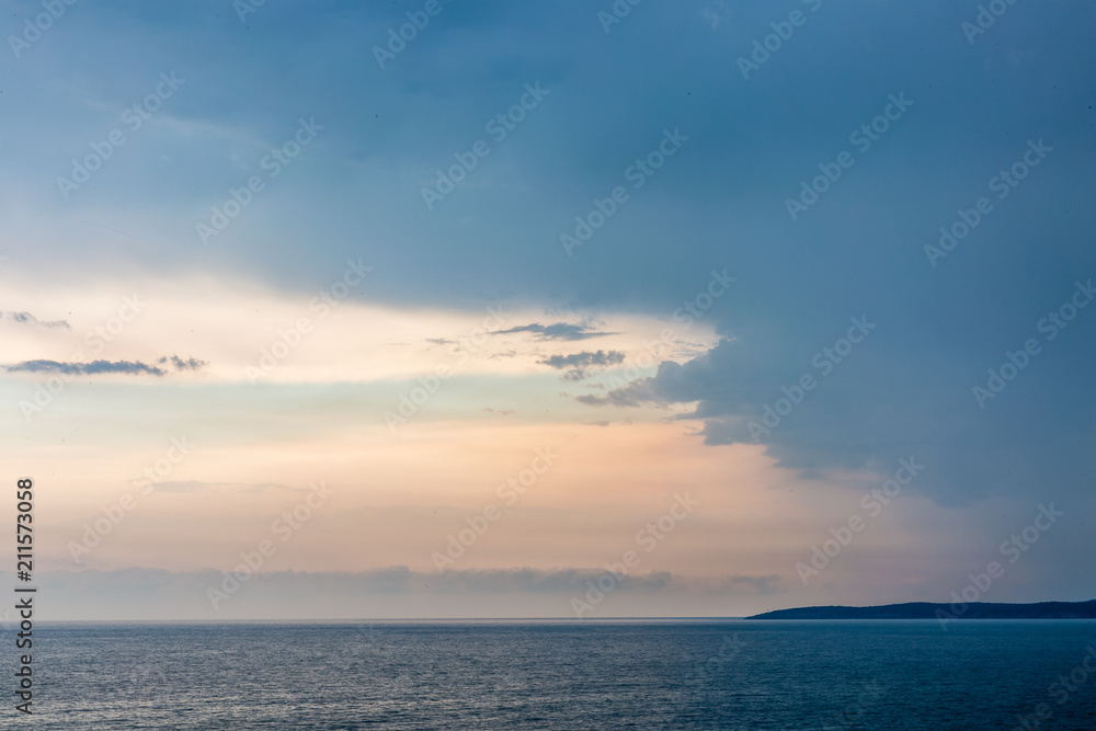 Seascape with dramatic sky and clouds on sunset