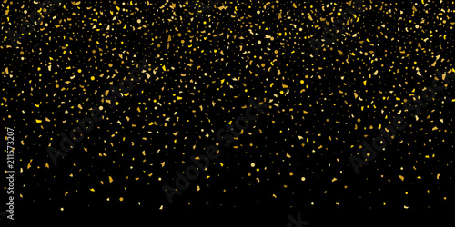 Glitter of golden particles of confetti on a black