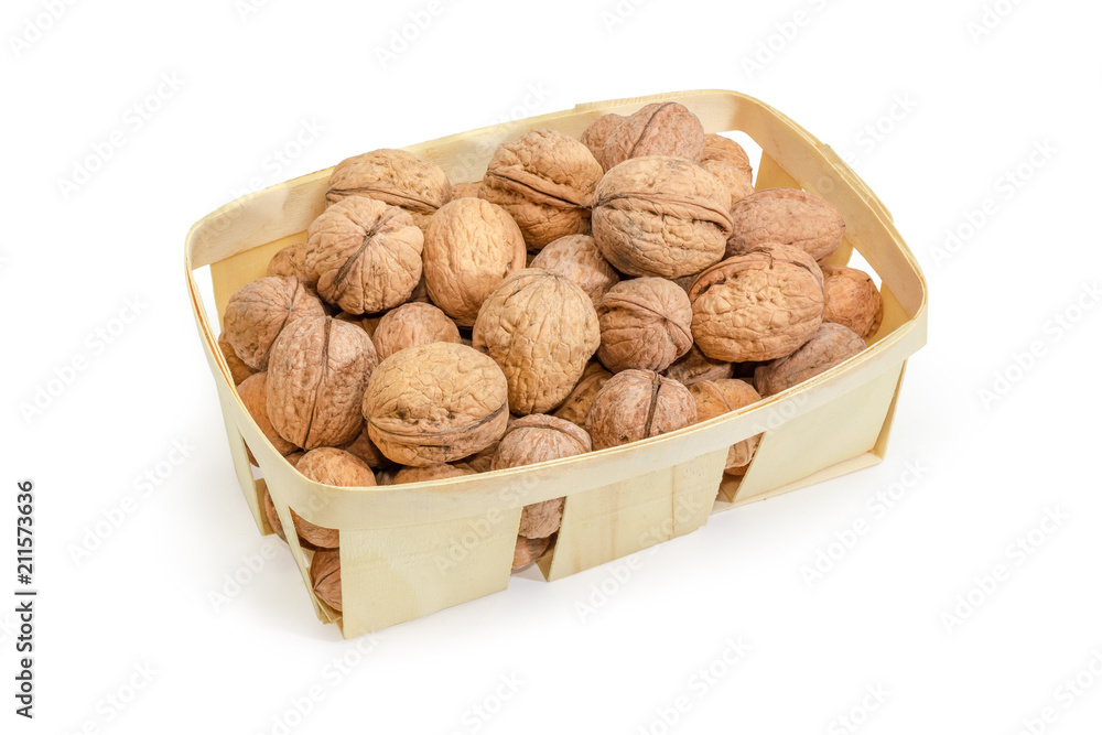 Ripe walnuts in wooden basket on a white background Ripe walnuts in wooden basket on a white background