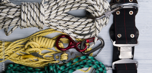 on a light background lie, a set of ropes, and a safety belt, for climbers, a kind of background