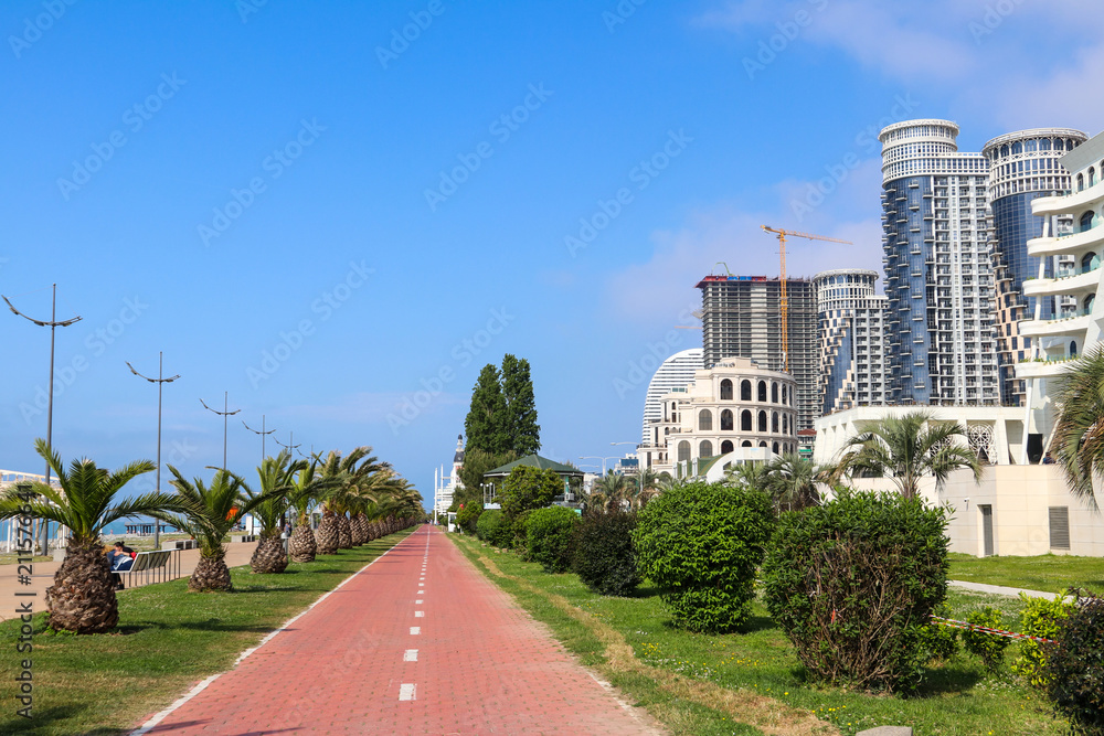 Embankment of Batumi with alley of palm trees, bicycle path and modern architecture