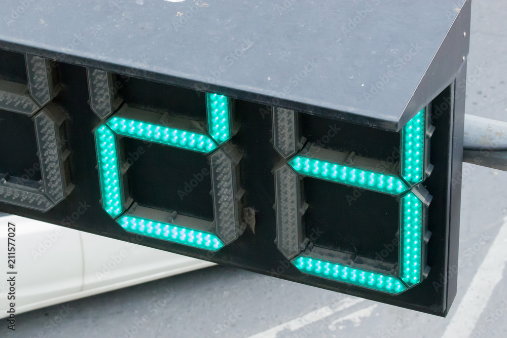 Fototapeta premium LED Number powered traffic light, shining green, viewed up close.