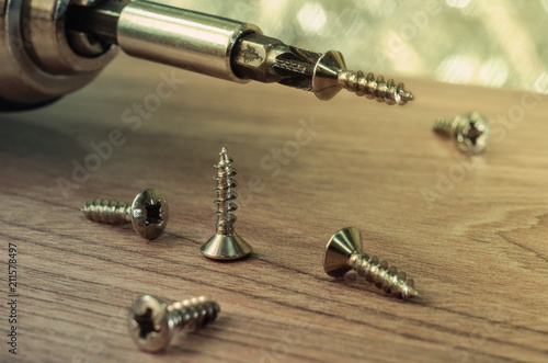 Photos number of screws on the wooden background