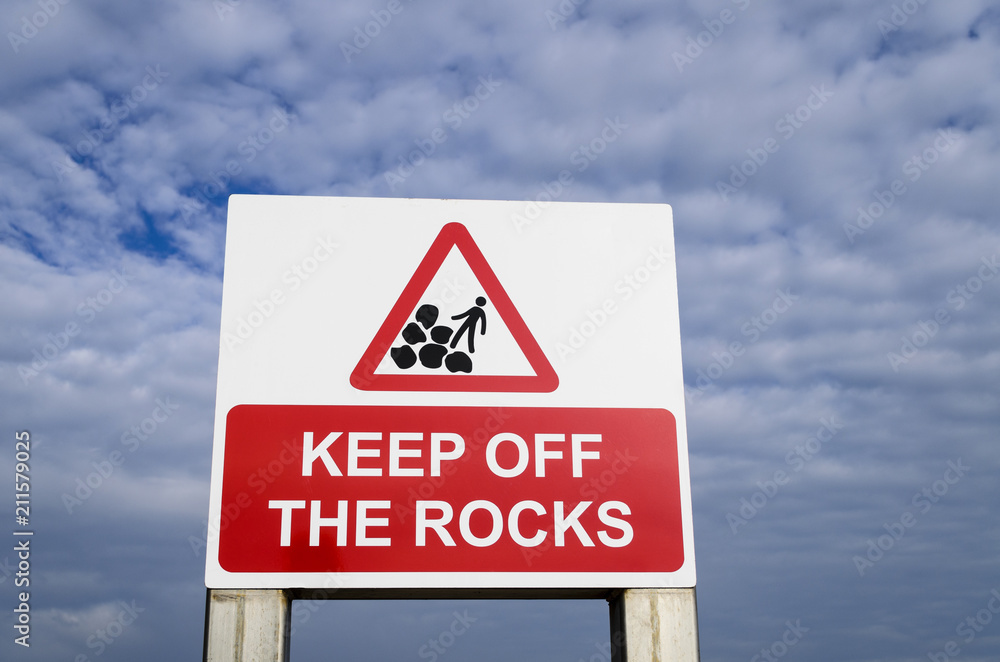 A danger sign saying keep off the rocks, UK