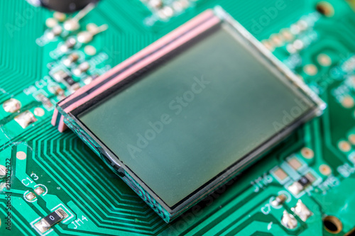 Miniature LCD panels on the motherboard. Circuit Board close-up. Detail of an electronic printed circuit board with mounted display screen.