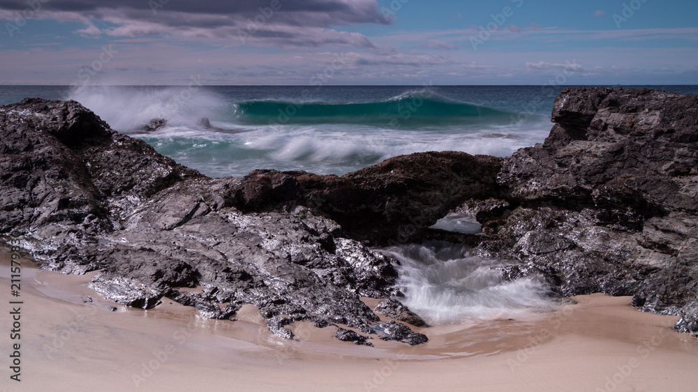 Waves crashing over Snapper Rocks