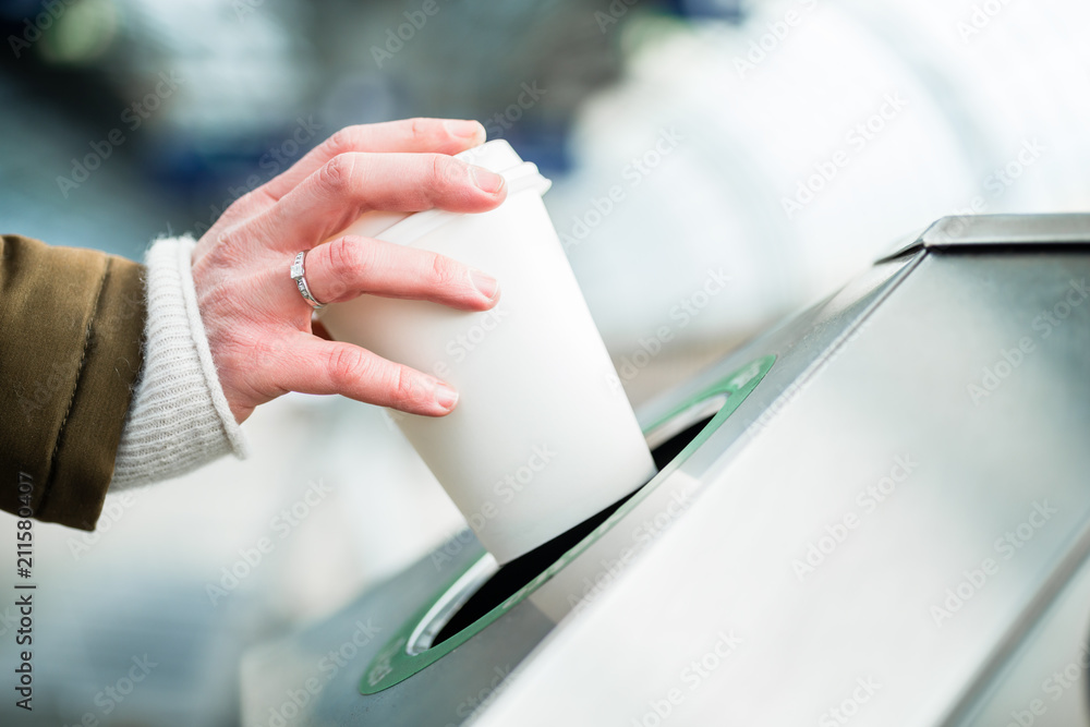 Woman using waste separation container throwing away coffee cup made of Styrofoam Stock Photo