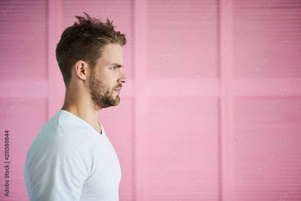 Profile of solemn man frowning in discontent. He is standing and