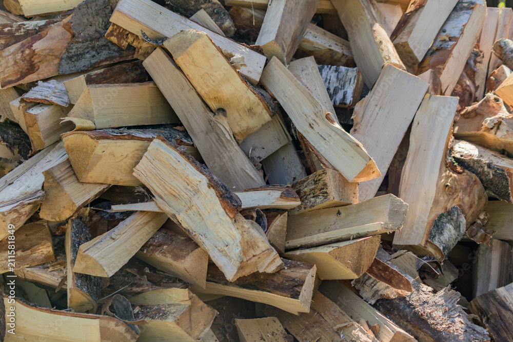 A stack of dry firewood, prepared for winter for heating the house. A stack of dry firewood, prepared for winter for heating the house.