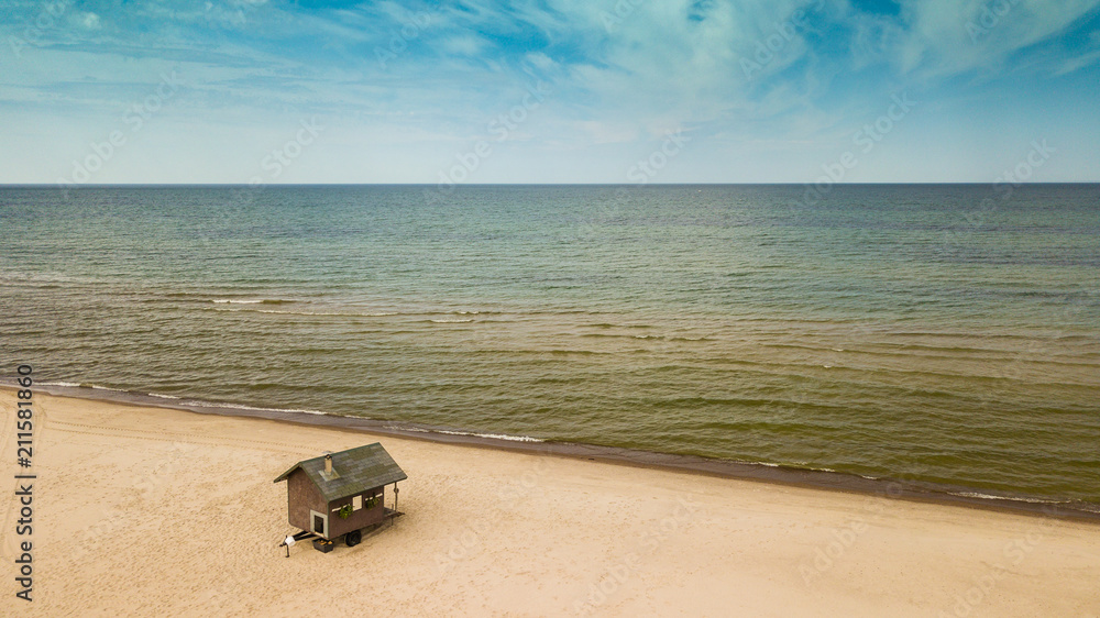 Small sauna house on the seashore. Bathhouse. Sandy beach. Small sauna house on the seashore. Bathhouse. Sandy beach.