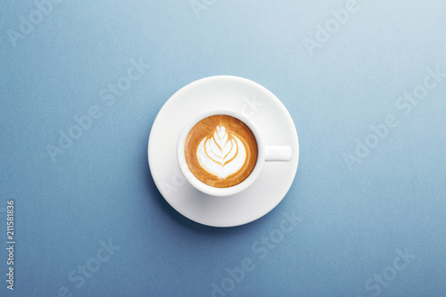 Valokuvatapetti A cup of cappuccino with beautiful latte art on blue background