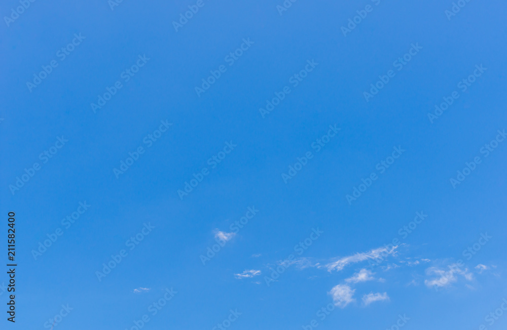 Blue sky background with tiny clouds.