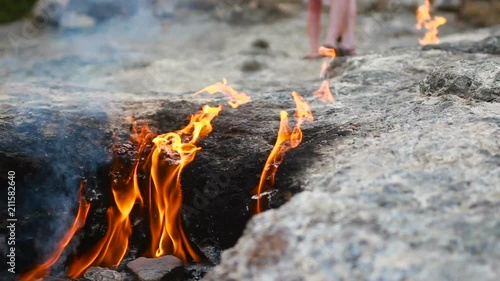 fire burns from under the stones photo