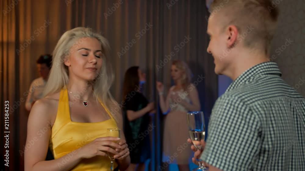 Sexy lady flirt with young man at private apartment flat party, drink champagne cocktail in love having fun together feeling attraction. Ultra HD. Sexy lady flirt with young man at private apartment flat party, drink champagne cocktail in love having fun together feeling attraction. Ultra HD.