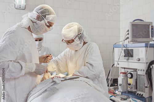 Two surgeons and  nurse in operating room. photo